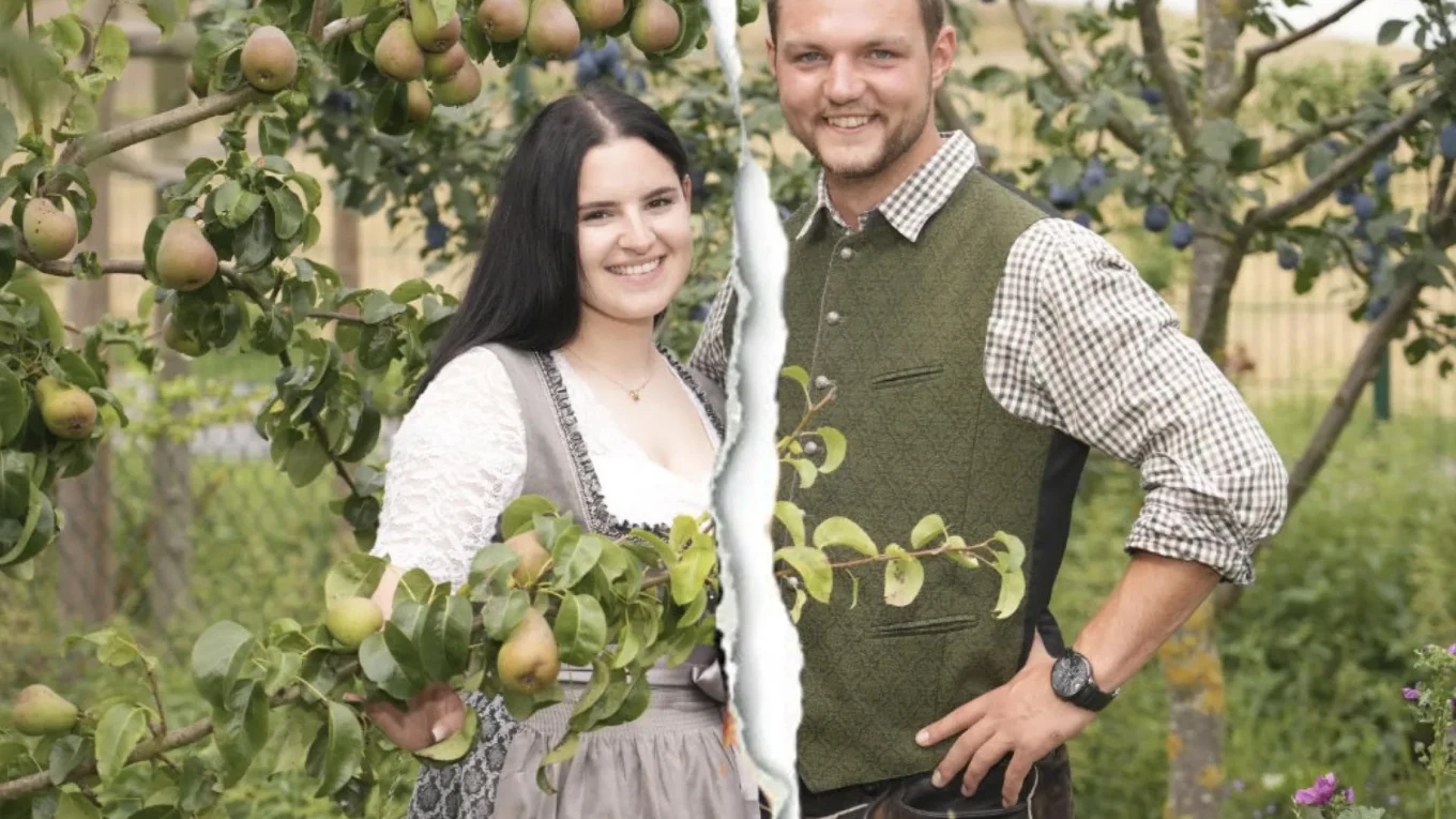 Smiling couple in traditional clothing standing among pear and plum trees in an orchard.